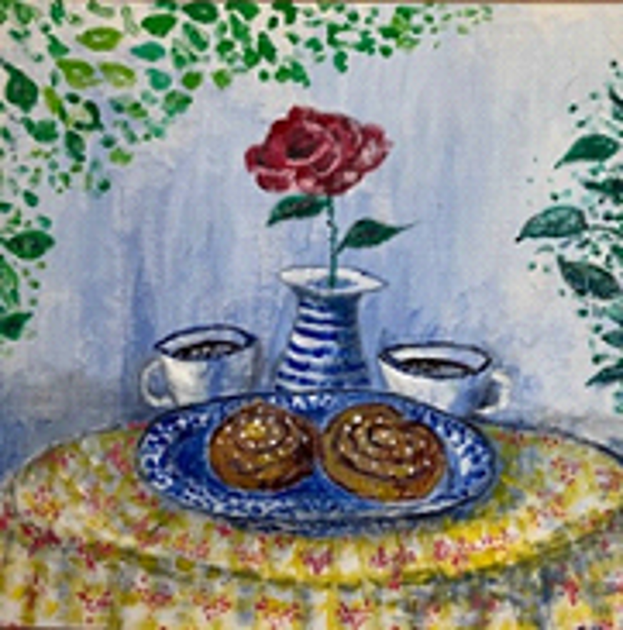 Målningen visar ett dukat runt bord med en gulröd blommig duk. På bordet står ett blåvitt fat med två kanelbullar, och bakom fatet finns två vita koppar med mörk dryck, troligen kaffe. I mitten står en blåvitrandig vas med en röd ros och gröna blad. Bakgrunden är ljusblå med gröna bladverk som sträcker sig in från hörnen, vilket skapar en inramning. Helheten ger ett varmt, hemtrevligt och inbjudande intryck.